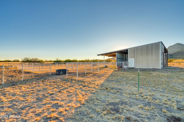 view of yard featuring a rural view and an outdoor structure