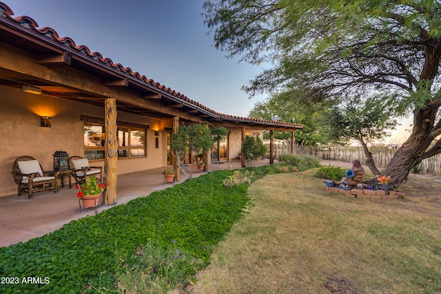 yard at dusk with a patio