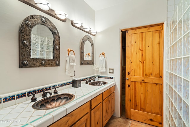 bathroom with dual bowl vanity and tile flooring