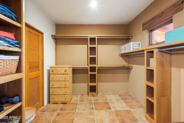 spacious closet featuring light tile floors