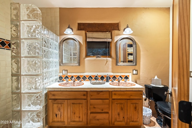 bathroom featuring tile walls, backsplash, and double vanity