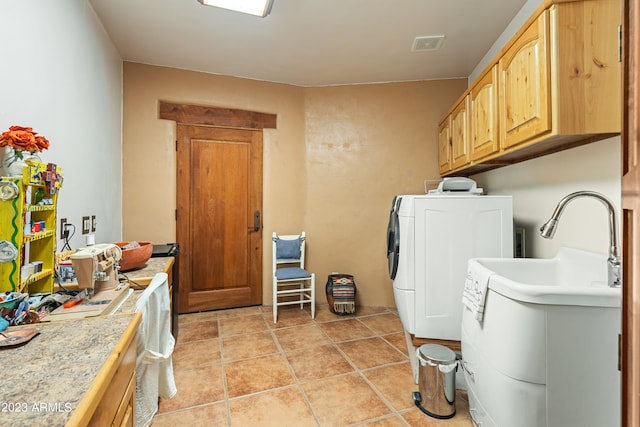 washroom featuring light tile flooring and washer and clothes dryer