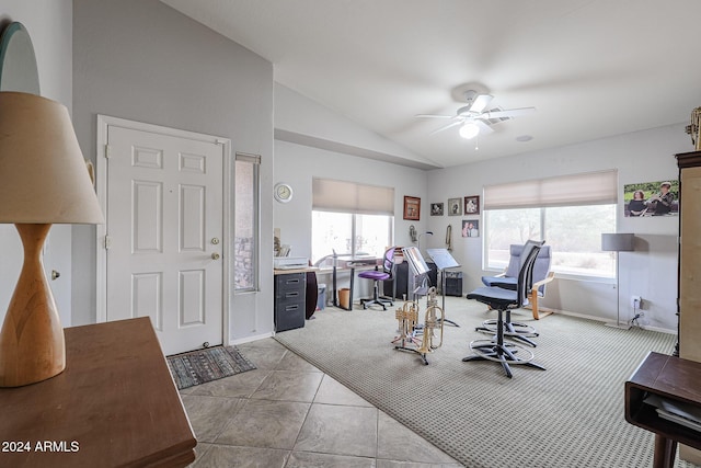 office area with ceiling fan, light tile patterned flooring, and vaulted ceiling