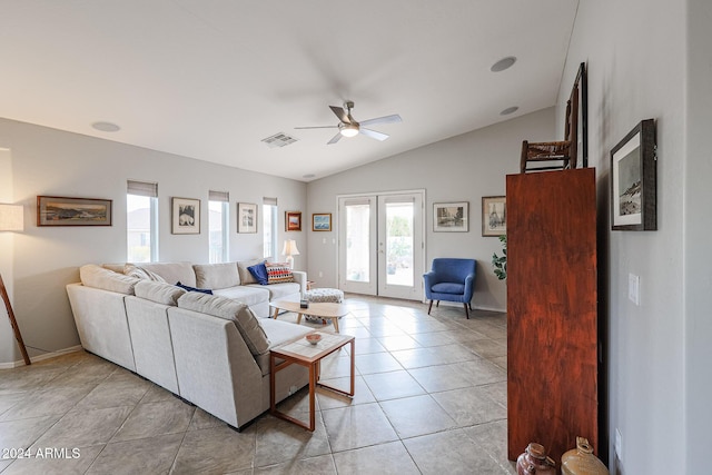 living room featuring french doors, light tile patterned floors, vaulted ceiling, and ceiling fan