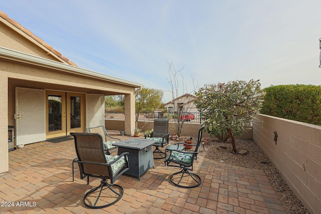 view of patio / terrace featuring french doors and a fire pit