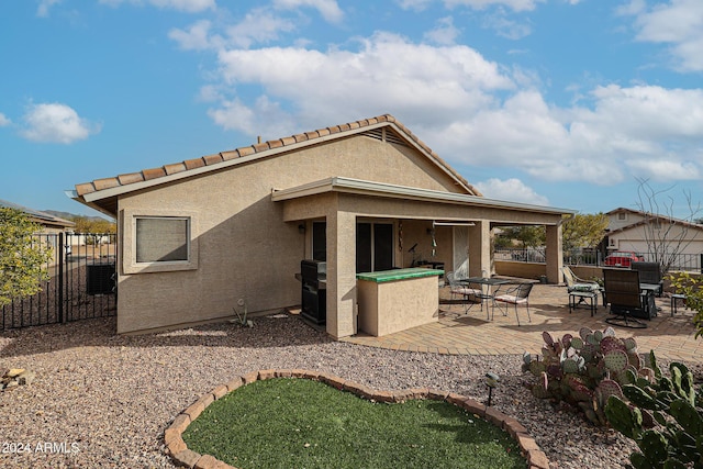 back of house with a patio