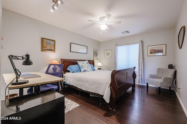 bedroom with dark hardwood / wood-style floors and ceiling fan