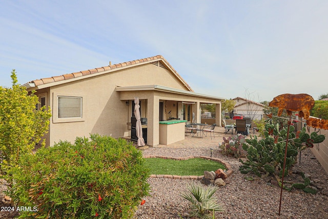 back of property featuring a patio