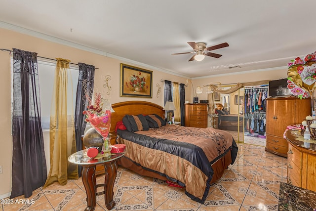 bedroom with crown molding, ceiling fan, and light tile patterned flooring