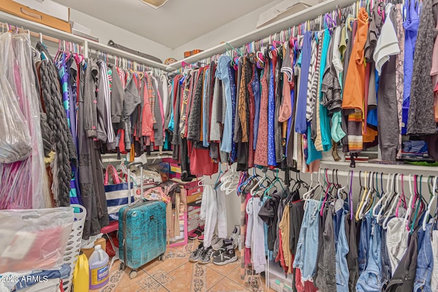 spacious closet featuring tile patterned flooring