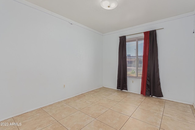 tiled empty room featuring crown molding