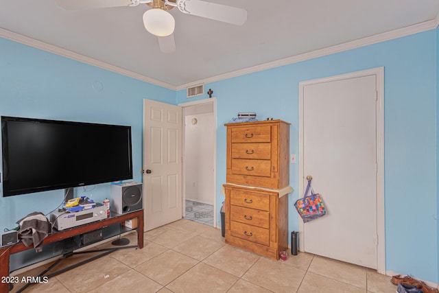 tiled bedroom featuring ornamental molding and ceiling fan