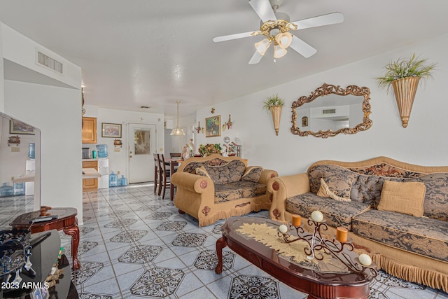 tiled living room featuring ceiling fan