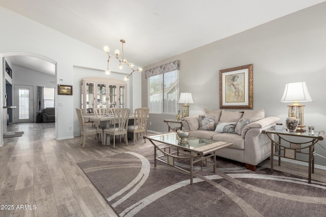 living room featuring hardwood / wood-style flooring, a wealth of natural light, and a chandelier