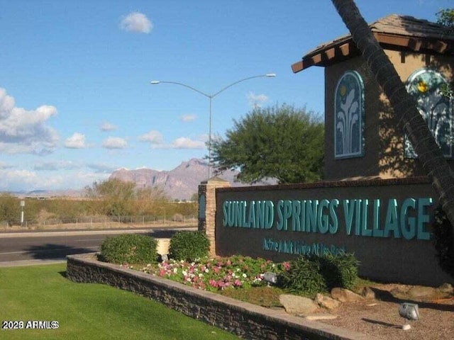 community sign featuring a mountain view