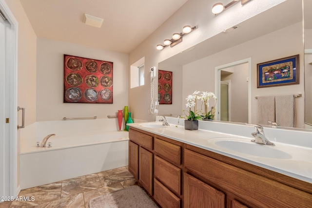 bathroom featuring vanity and a washtub