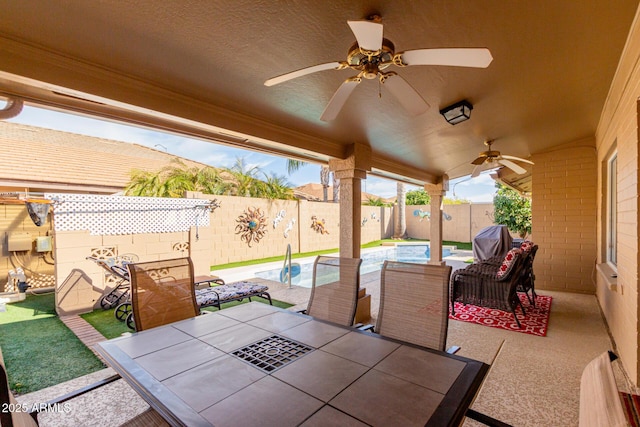 view of patio with a fenced in pool and ceiling fan