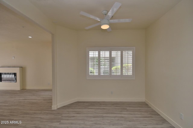 empty room featuring light hardwood / wood-style floors and ceiling fan