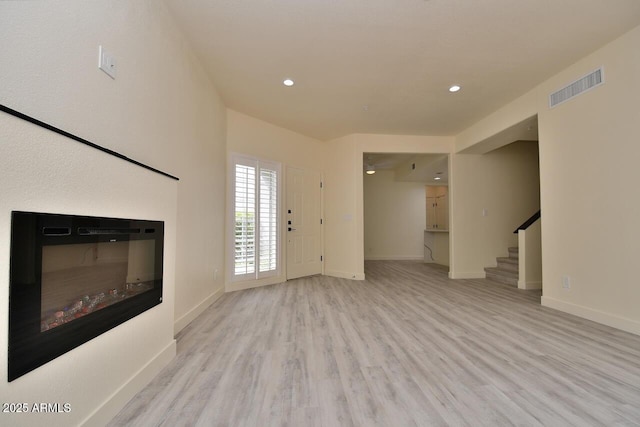 unfurnished living room with light wood-type flooring