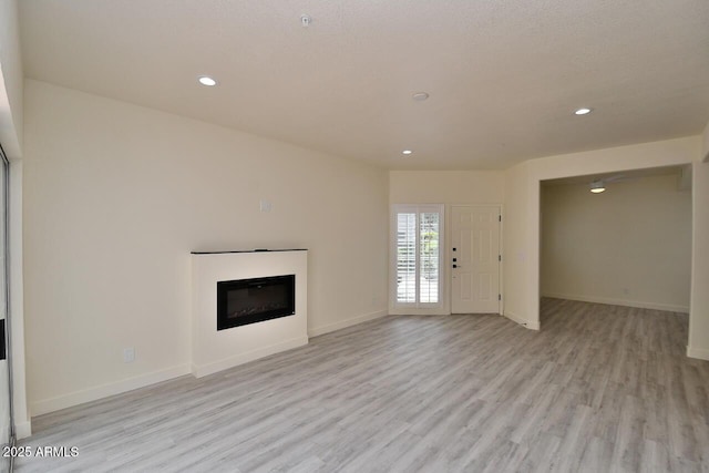 unfurnished living room with light wood-type flooring