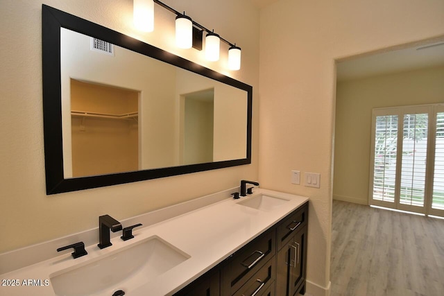 bathroom with vanity and hardwood / wood-style flooring