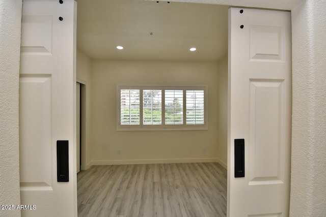 unfurnished room featuring light hardwood / wood-style flooring