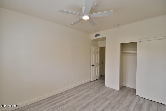 unfurnished bedroom with ceiling fan, a closet, and light hardwood / wood-style flooring