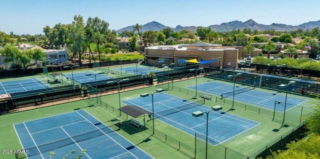 view of tennis court featuring a mountain view