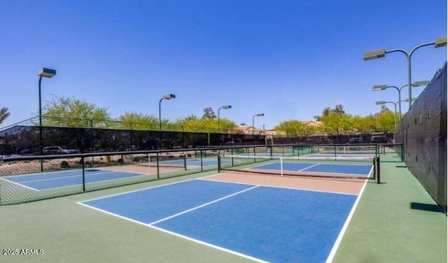 view of tennis court featuring basketball hoop