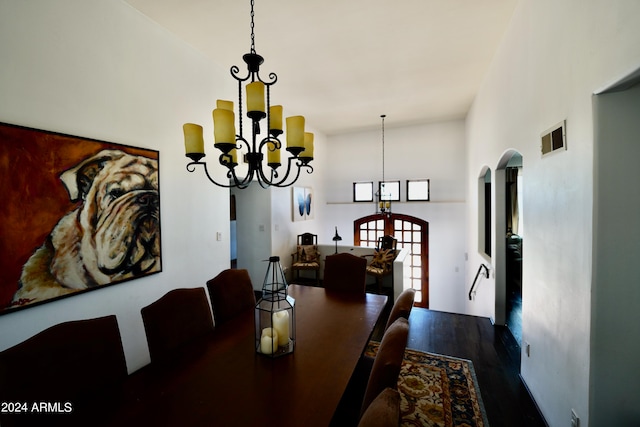 dining room with wood-type flooring and a chandelier