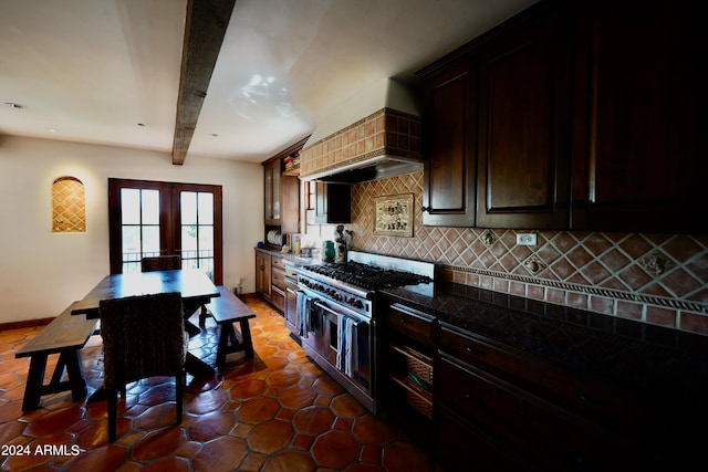 kitchen featuring dark tile patterned floors, beam ceiling, tasteful backsplash, custom range hood, and double oven range