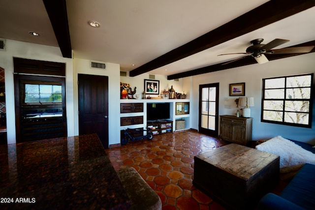 living room featuring ceiling fan and beamed ceiling