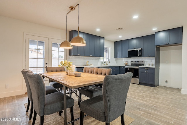 dining area featuring visible vents, recessed lighting, light wood-type flooring, and baseboards