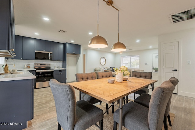 dining room featuring recessed lighting, visible vents, and light wood-type flooring