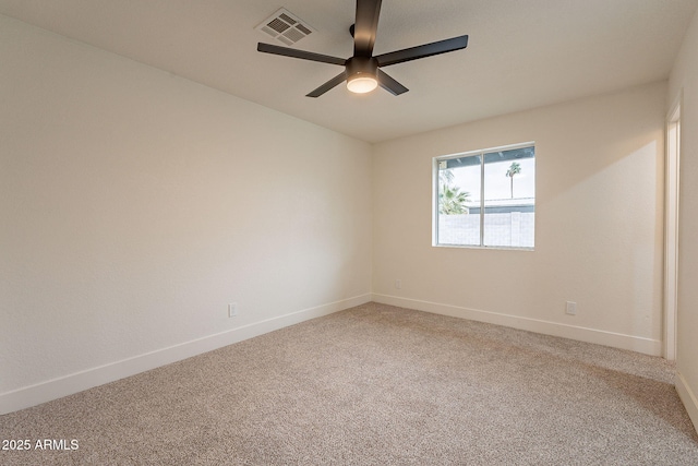 spare room featuring baseboards, visible vents, carpet floors, and ceiling fan