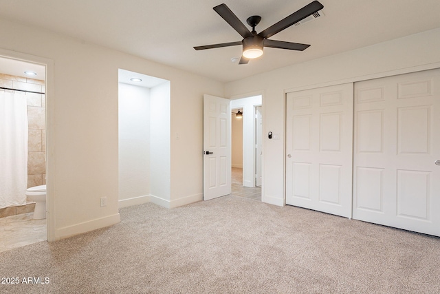 unfurnished bedroom with visible vents, baseboards, carpet floors, a closet, and ensuite bath