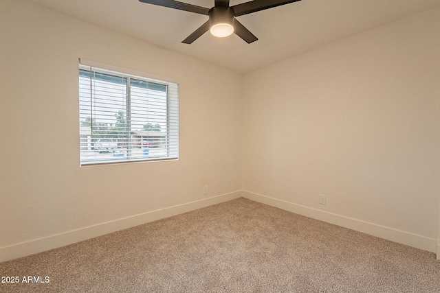 unfurnished room with baseboards, light carpet, and a ceiling fan