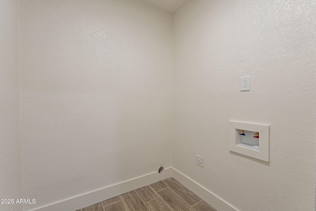 laundry area featuring electric dryer hookup, laundry area, baseboards, hookup for a washing machine, and wood tiled floor