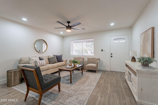 living room with wood finish floors, baseboards, ceiling fan, and recessed lighting