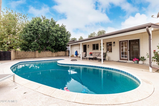 view of swimming pool featuring an outdoor living space and a patio area