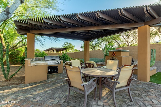 view of patio featuring a pergola, grilling area, and exterior kitchen