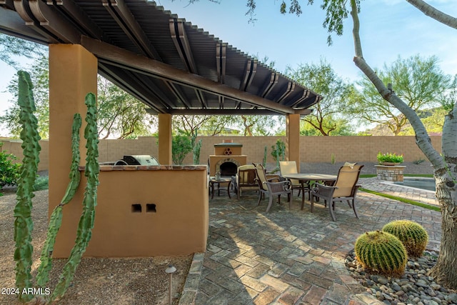 view of patio featuring an outdoor kitchen and exterior fireplace