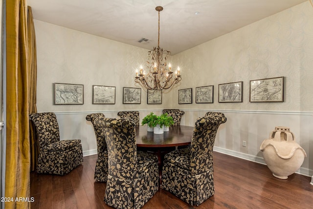 dining area with dark wood-type flooring and a chandelier