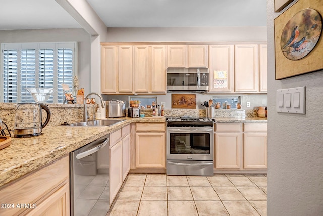 kitchen featuring light tile patterned flooring, sink, and appliances with stainless steel finishes