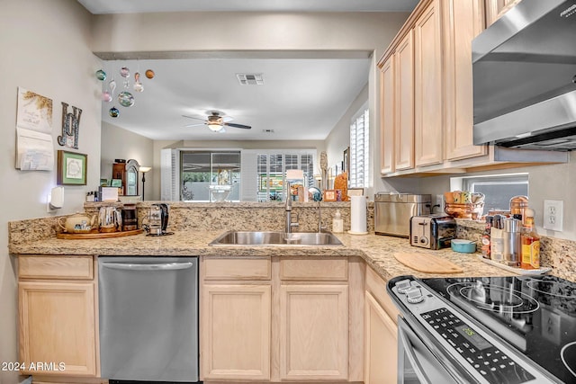 kitchen with ceiling fan, sink, stainless steel appliances, kitchen peninsula, and light brown cabinetry