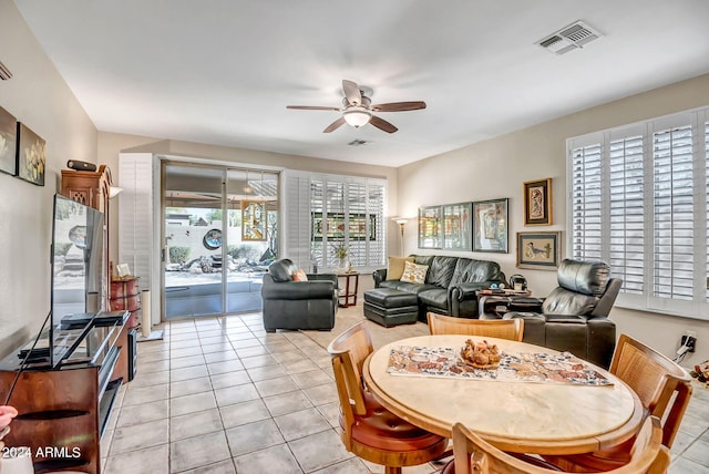 tiled dining space featuring ceiling fan and a wealth of natural light