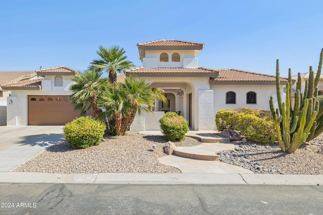 mediterranean / spanish-style home with a garage