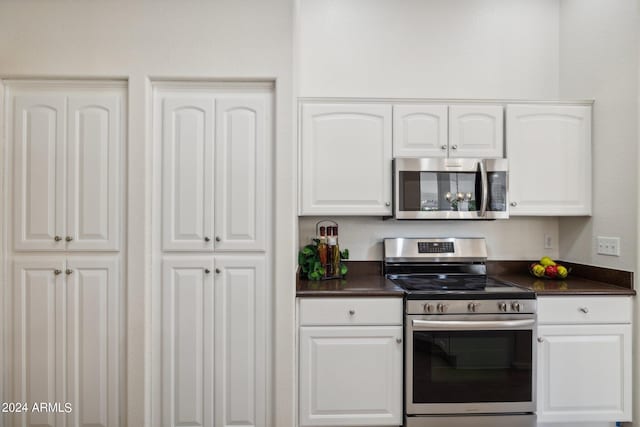 15016 W Monterey Way, Goodyear, AZ 85395 - kitchen with stainless steel appliances, white cabinetry, and dark countertops