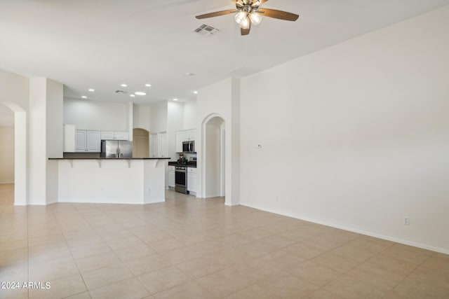 unfurnished living room with ceiling fan