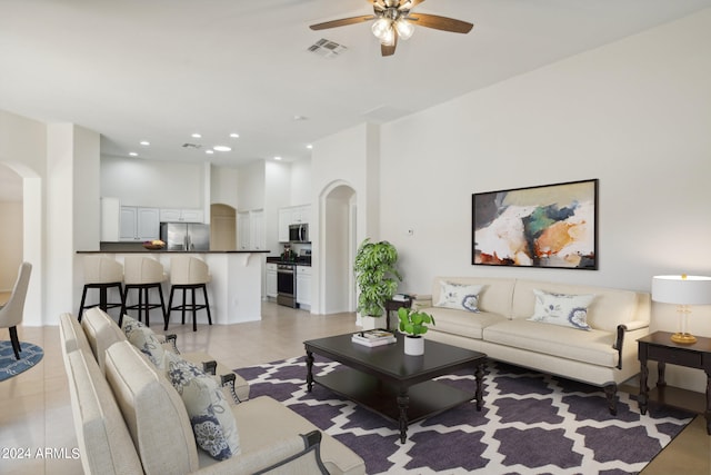 living room featuring ceiling fan and light tile patterned floors